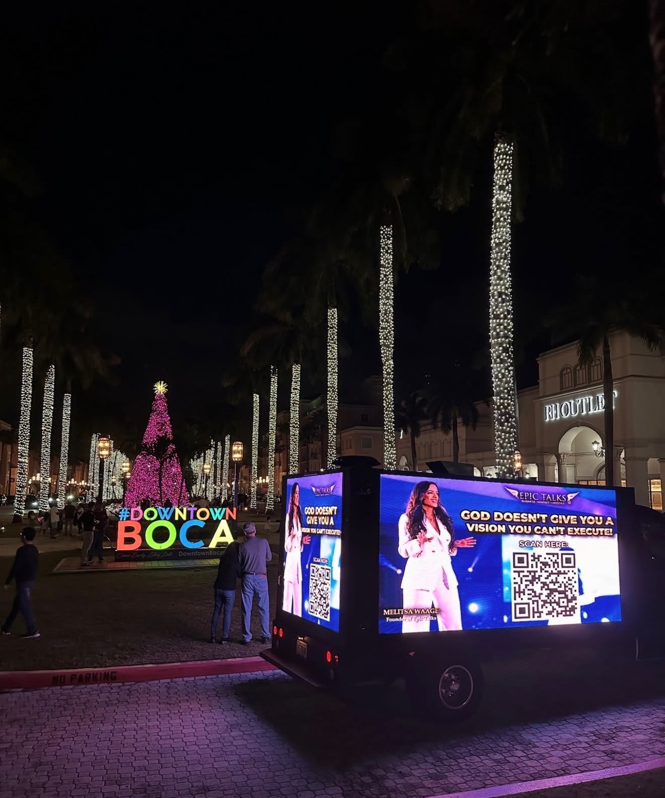 Presidential LED Truck illuminated at night on a downtown street, showing a bright advertising creative to pedestrians.